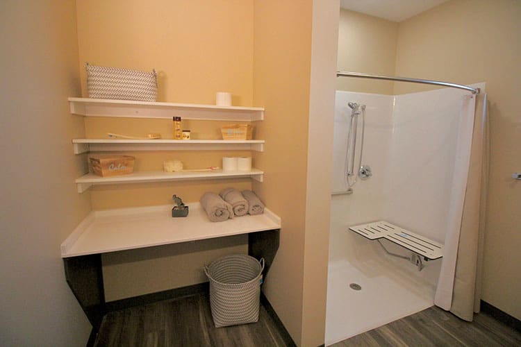 Charter Senior Living of Oak Openings, IL resident suite's bathroom with decor and folded linen