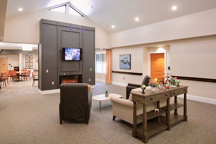 Charter Senior Living of Oak Openings, IL activity room and living room with a lit fireplace
