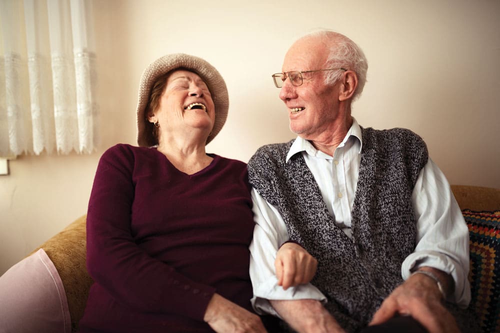 Memory Care Residents sitting beside each other on a couch